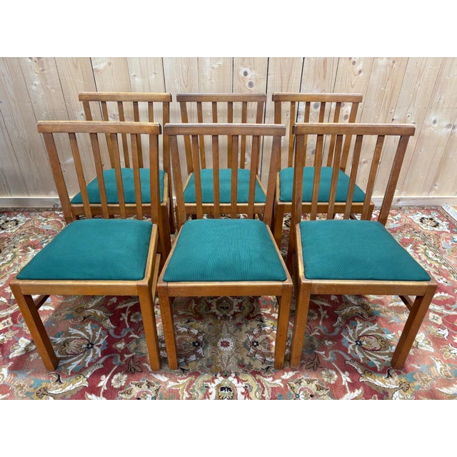 Set of six solid wood chairs, meticulously crafted with clean lines, typical of the second half of the 20th century. The...