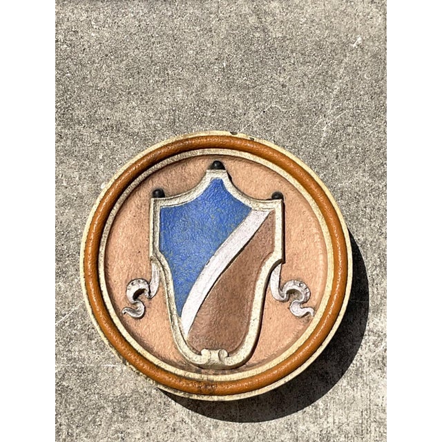 This vintage round heraldic crest architectural element is a distinguished decorative plaque that reflects the enduring...