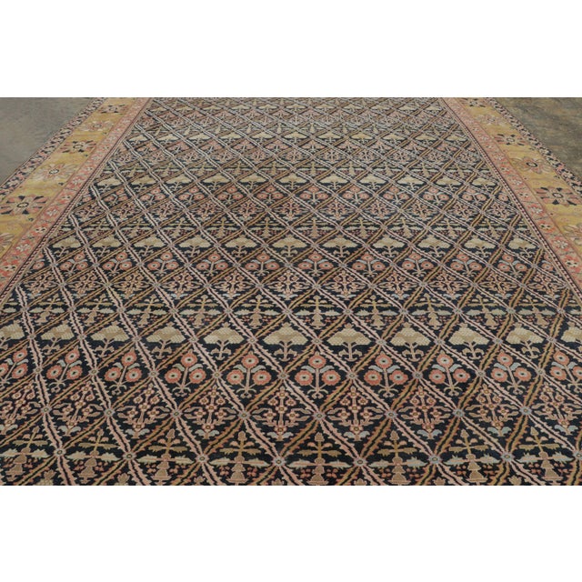 Hand-knotted in wool and dating to circa 1950–1960, this vintage 13x19 Persian rug is a sophisticated example of an all-...