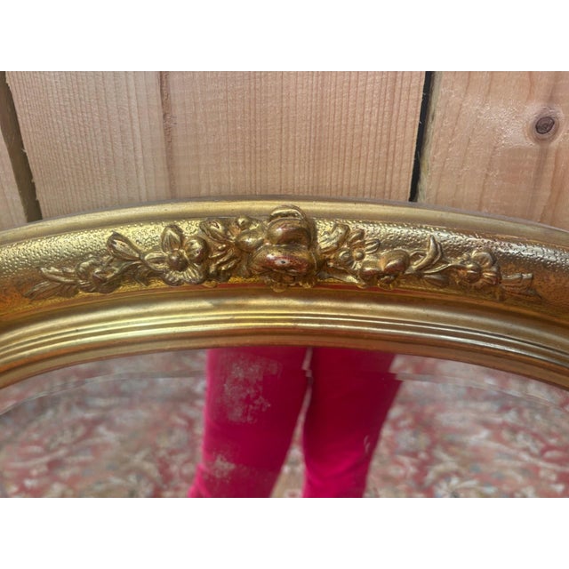 Magnificent antique oval mirror with a beveled glass, made in France during the 20th century in the purest Louis XVI...