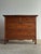 Solid oak chest of drawers with two over two drawer configuration and original brass bail hardware. Paneled sides and...