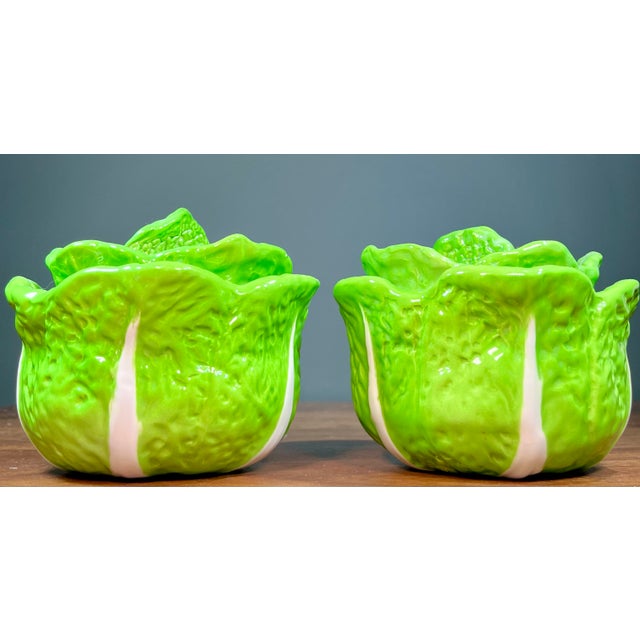 Lime green lidded cabbage pottery bowls with a white stripe accent.