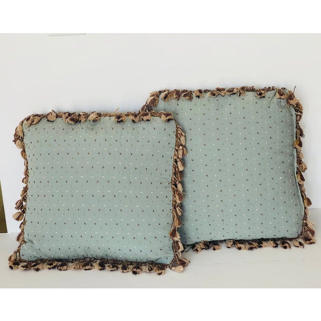 Pair of lovely lumbar pillows with dots embroidery and fringes.