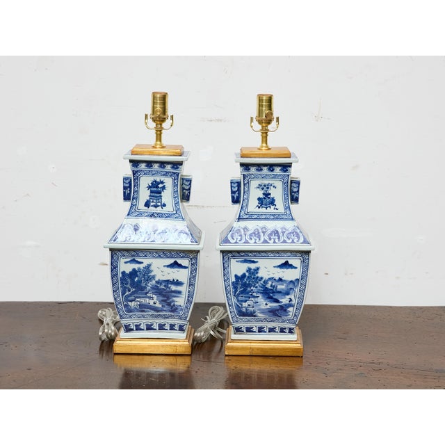 This pair of blue and white porcelain table lamps was custom-assembled from early 20th-century Asian vessels, likely...