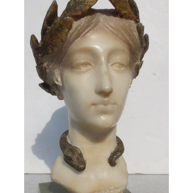 Hygieia carved in alabaster and polychromed with gilt and bronze tones. Art Nouveau goddess with her symbol of the serpent...