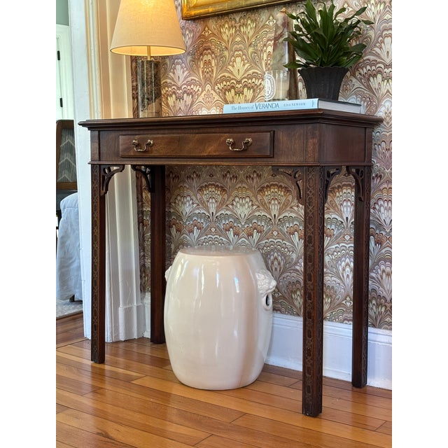 A burl wood top and just the right amount of Chippendale-style fretwork give this super solid console table by renowned...