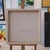 This evocative artwork presents a figure seated with their back to the viewer, rendered in an exquisite blend of...