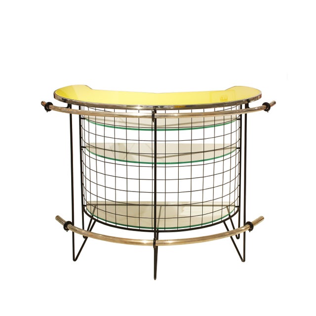 Elegant Italian bar from the 1950s, defined by its distinctive curved form and light, architectural structure. The piece...
