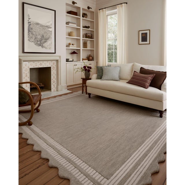 The Scottie Collection from Chris Loves Julia x Loloi is a hand-tufted wool area rug with a playful scalloped edge and...