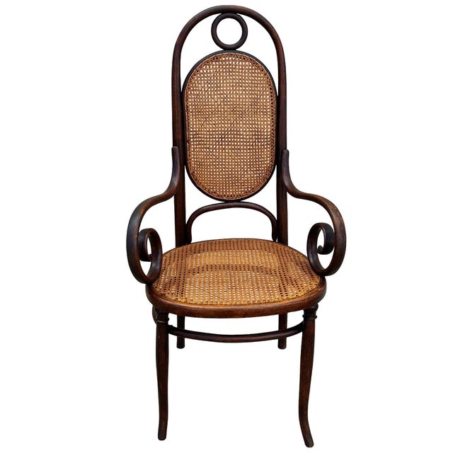 Victorian high back Thonet number 17 armchair features an elegant, sculptural frame crafted from warm-toned bentwood with...