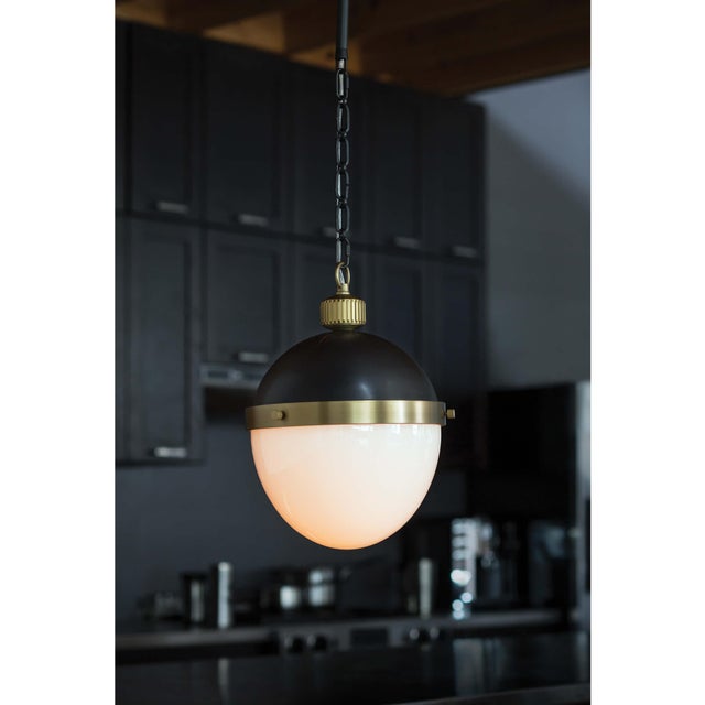 Commanding tradition and style, our Otis Pendant features a bold collaboration of metal and frosted glass—suspended by an...