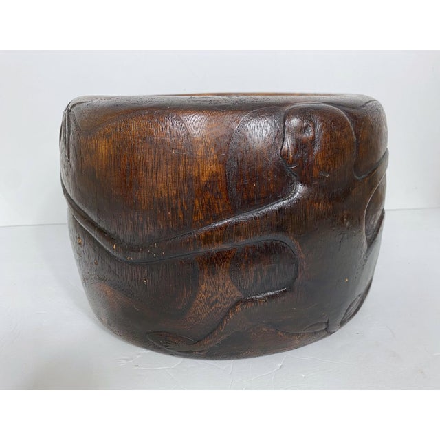 A Hibachi and Paulownia brazier. A carved monkey wrapped around the brazier. Copper liner