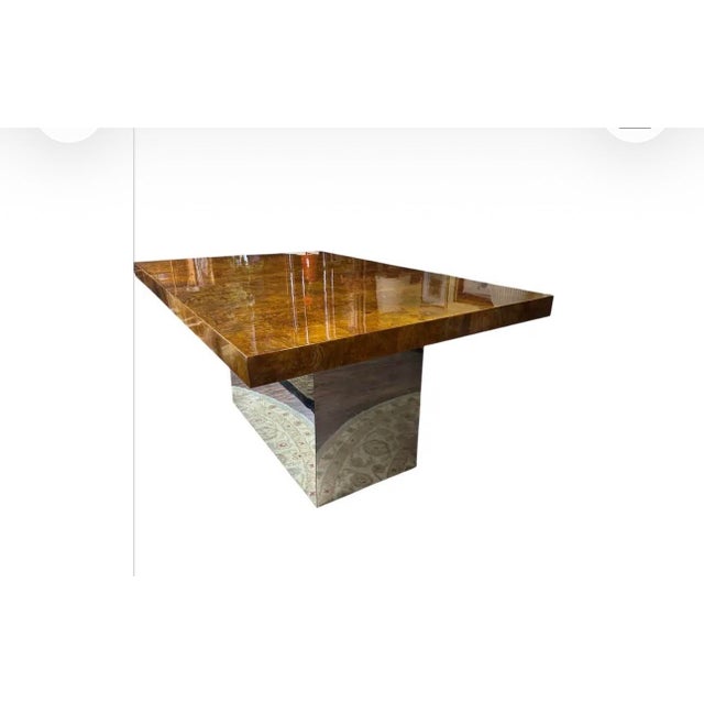 Attributed to Milo Baughman, this striking olive burl extension dining table is a true statement piece, combining...