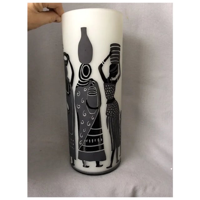 A Cameo Glass Vase featuring an African, Ethnographic motif. The Vase is handmade an features a cut design in black and...