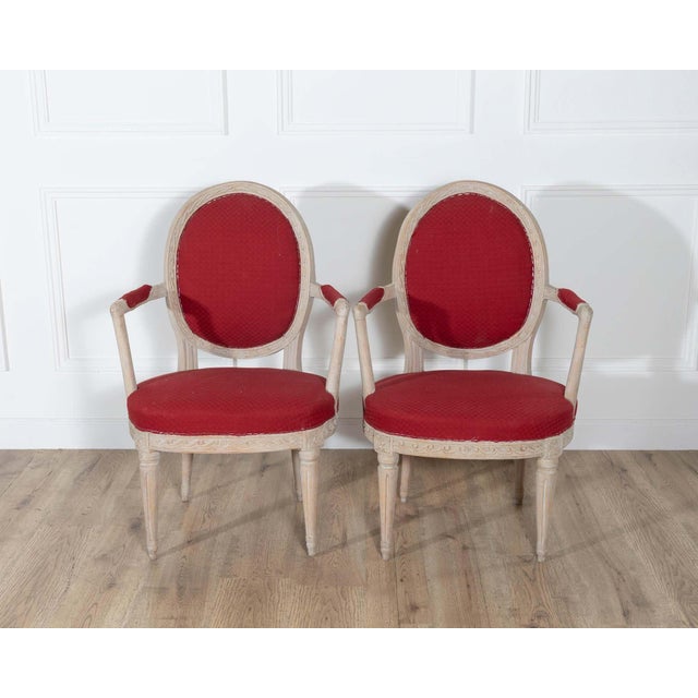 Refined pair of Swedish Gustavian armchairs, circa 1820, retaining their original pale painted finish and classic...