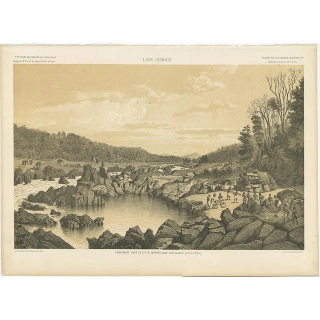 This antique print shows a detailed view of a camp set along the Mekong River near the rapids of Keng Chan in Laos. The...