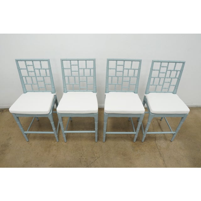 Beautiful set of four light blue faux bamboo-style chairs featuring decorative geometric lattice backs, removable white...