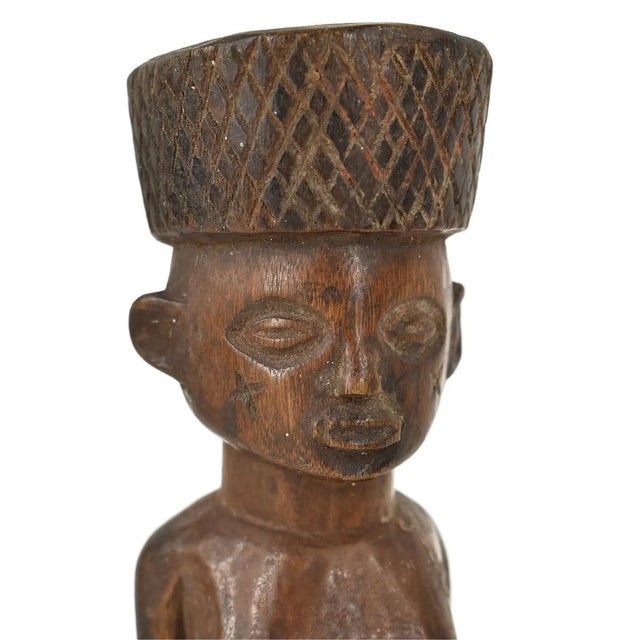 The Mbole Standing Female Miniature Figure from Congo is a captivating expression of cultural identity and artistic...