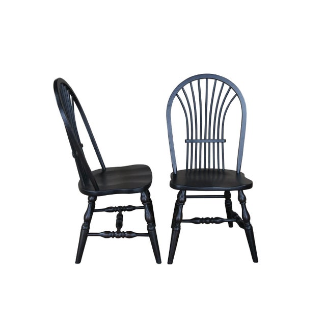 A set of six Windsor farmhouse dining chairs. Made of oak featuring black painted finish with a bentwood slatted sheaf...