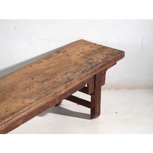 This antique Chinese kang bench, crafted in solid elm wood and dating from the late Qing dynasty to the early Republican...