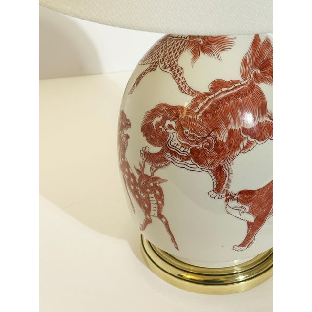 A chinoiserie porcelain table lamp by porcelaine de paris, france, dating to the 1970s, featuring vibrant copper red...