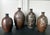 A set of four Japanese Ceramic Tokkuri Sake storage bottles circa early 20th century (Meiji to Taisho period). The bottles...