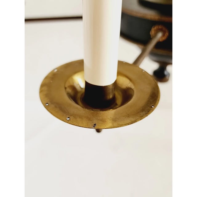 Decorative Empire-style chandelier crafted of painted wood with an antique brass finish. The design features six tall...