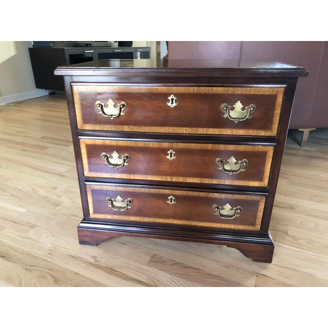 This petite and unique chairside chest was made by Columbia Manufacturing Co. The company was in business from the late...