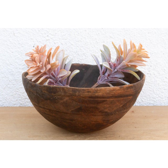 There is something deeply grounding about holding a vessel that was hewn by hand from a single block of wood. This antique...