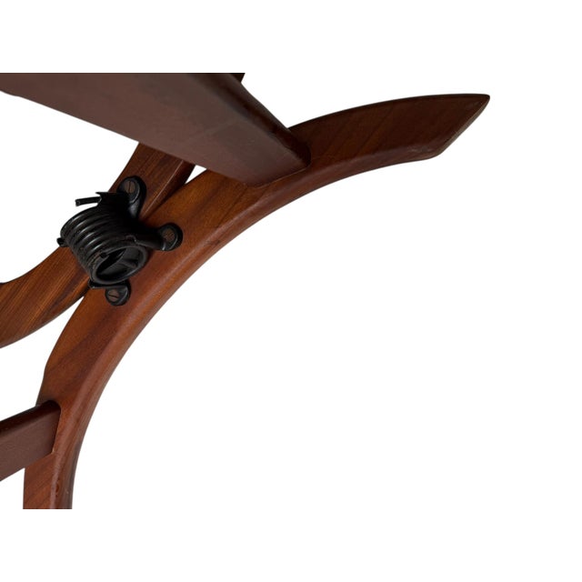 Stunning and elegant Mid-Century Modern rocking chair. Striking Danish design from the 1960s. Solid teak frame with...