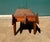 Long, low and narrow wood bench with sculptural tapered ends, and legs. Possibly walnut wood with a masonite top. The...