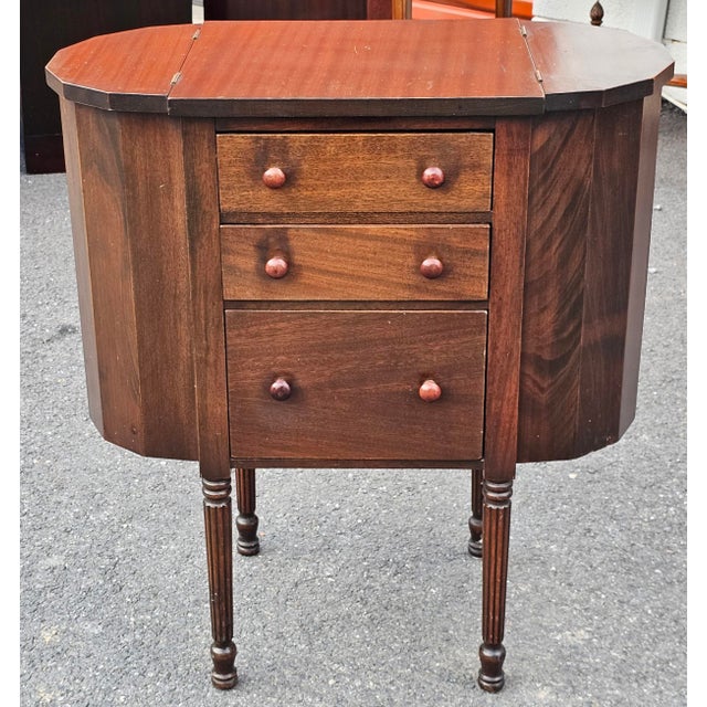An early 20th Century Martha Washington sewing cabinet, made of walnut and mahogany wood. Design Features: This style...