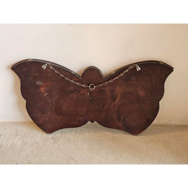 A sculptural Art Deco butterfly wall mirror dating from the 1930s, featuring a striking and highly decorative silhouette....
