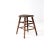 This antique wooden stool, dating to the early 20th century, features a gently sloped saddle seat and turned legs. Its...