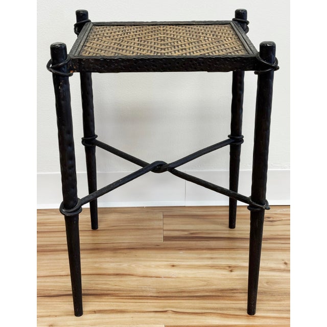 Vintage hammered cast iron frame side table with woven wicker top. Wonderful details to iron frame with twisted stretcher...