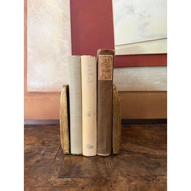 This striking pair of Italian Florentine bookends features hand-painted floral bouquets set against a rich ruby-red...