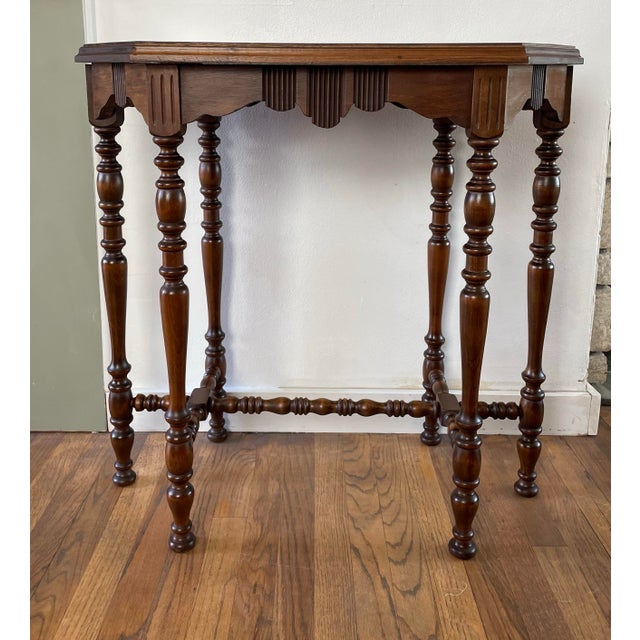 Antique side table featuring a striking octagonal top in richly figured burl walnut, with a molded edge and scalloped...