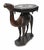 A superb anglo-indian carved hardwood camel side table, dating to circa 1820, finely modelled in the form of a standing...