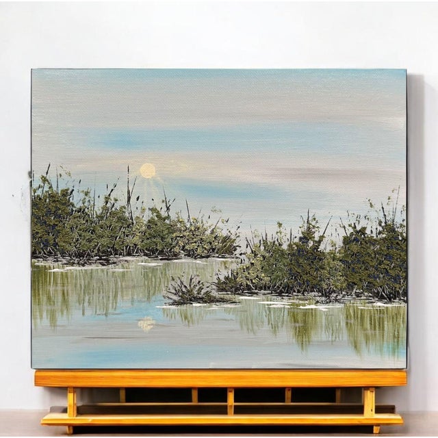 This serene acrylic painting features a tranquil lake surrounded by lush greenery, perfect for enhancing your home with a...