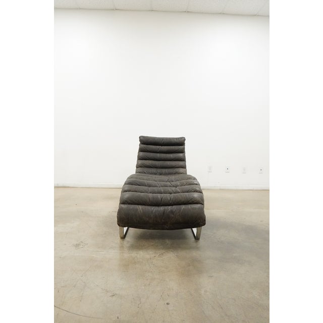 Dating to circa 2014, this contemporary chaise lounge from Restoration Hardware features a striking sculptural silhouette...