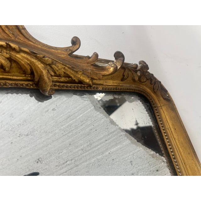 Louis xv style mirror in wood and gilt stucco charming pediment decorated with a shield of flowers and foliage gilt frame...