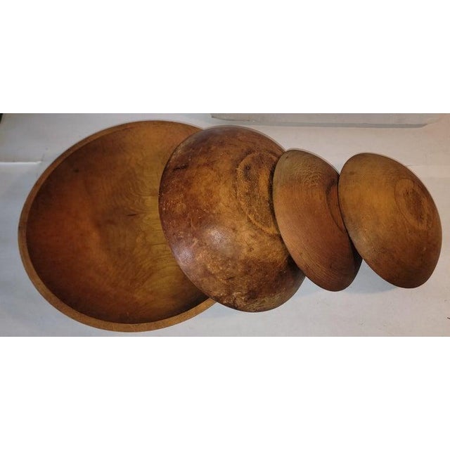 19thc collection of four hand carved wooden bowls. The bowls have great patina and wonderful age. Largest bowl measures -...