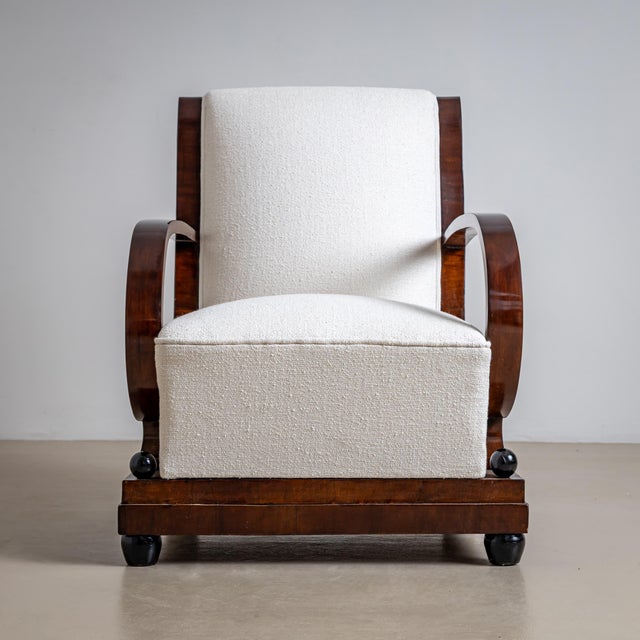 A pair of sophisticated Art Deco armchairs from the 1920s, featuring a gracefully curved beech wood frame and elegantly...