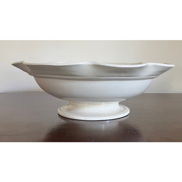 Antique 19th century Wedgwood creamware centerpiece bowl with ruffled rim and rising on a beaded pedestal foot. Marked on...