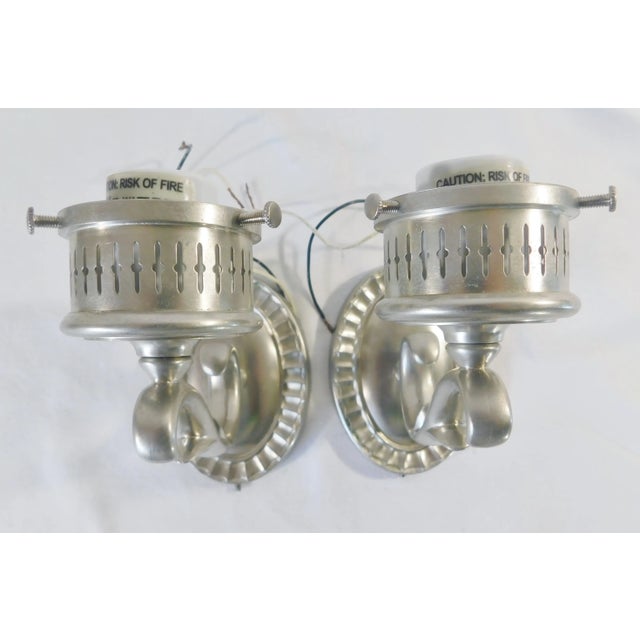 Pair Remains Lighting silver over solid brass electric wall lamp sconces. Made by Remains Lighting in 2008. Marked on back...
