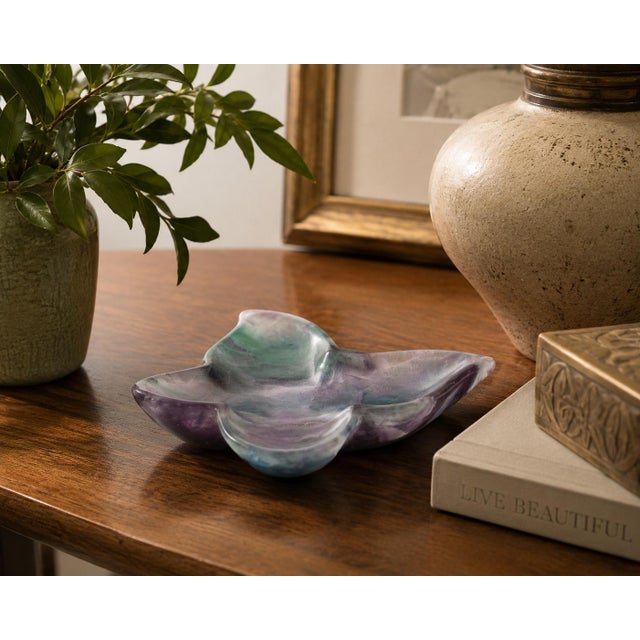 A charming pair of hand-carved butterfly dishes crafted from natural fluorite, displaying the gemstone's beautiful...