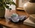 A charming pair of hand-carved butterfly dishes crafted from natural fluorite, displaying the gemstone's beautiful...