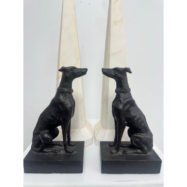 Charming pair of cast iron greyhound dog bookends with a dark bronze finish and nice weight. Each dog is seated on a...