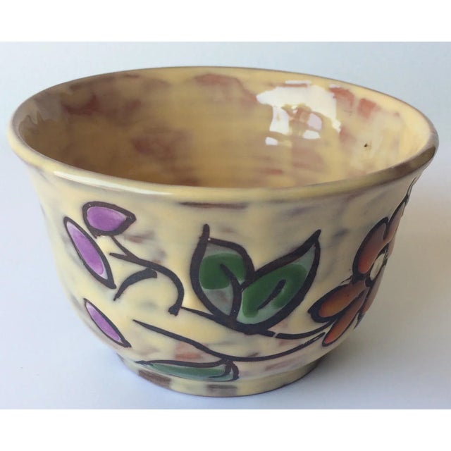 Handcrafted, hand painted French midcentury ceramic bowl. Beautifully decorated with floral designs and glazed. Signed on...