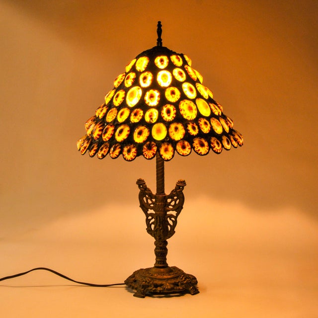 In incredible and unique statement lamp that features an antique gold cast iron double cherub lamp base and a handmade...